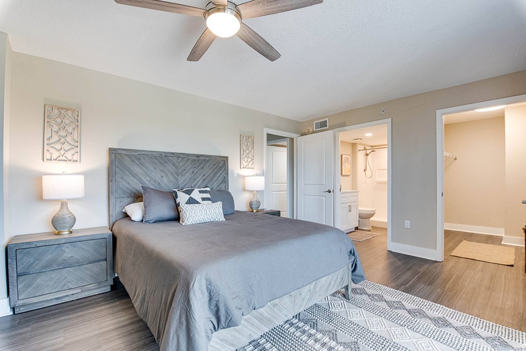 a bedroom with a bed and a ceiling fan