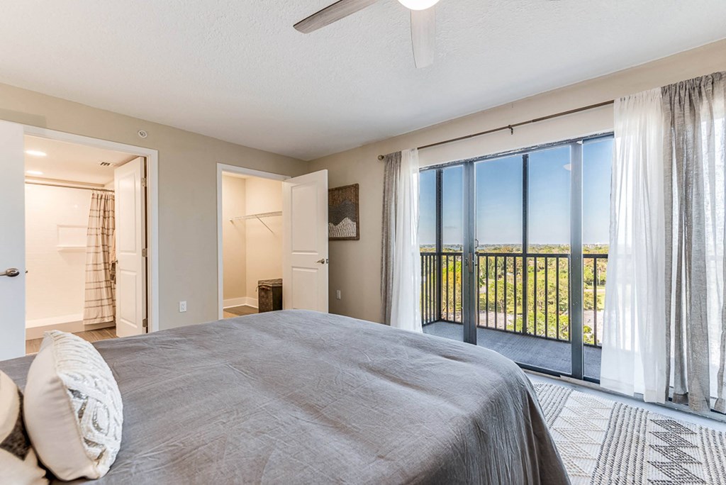 a bedroom with a large bed and a large window