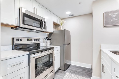 a kitchen with stainless steel appliances and white cabinets