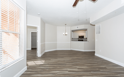 A room with a ceiling fan and a chandelier.