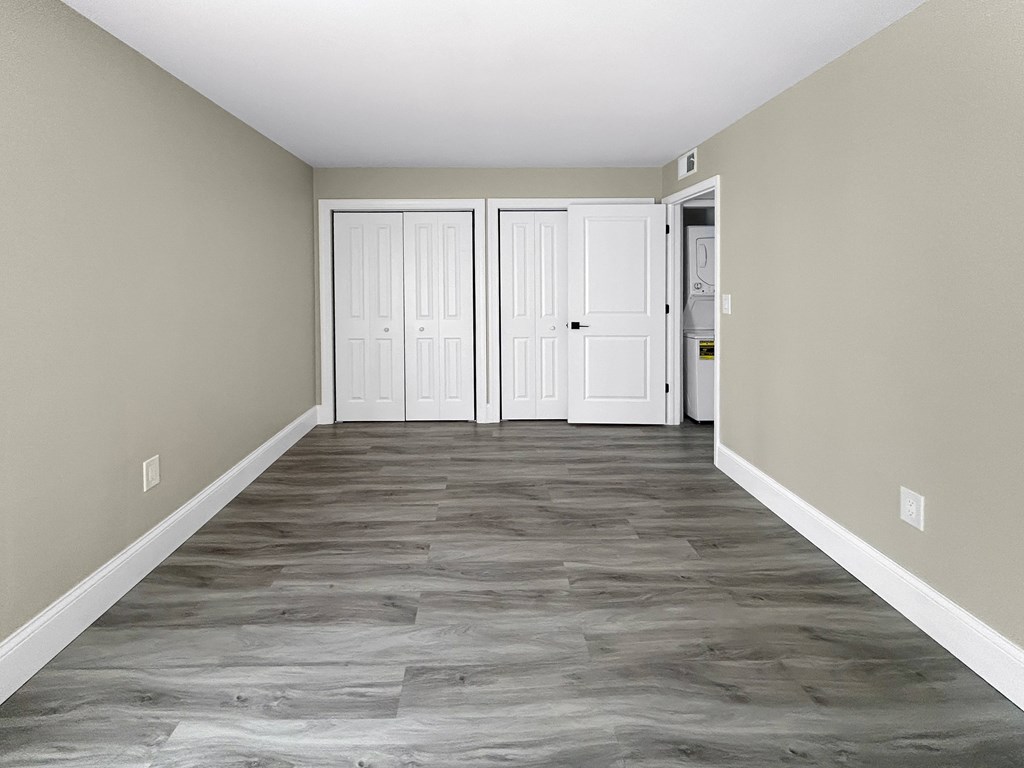 A hallway with two doors and a tiled floor.