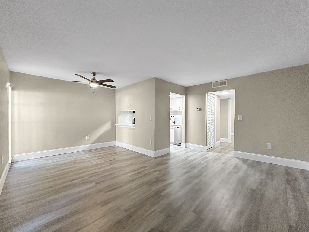 A room with a ceiling fan and light fixture.