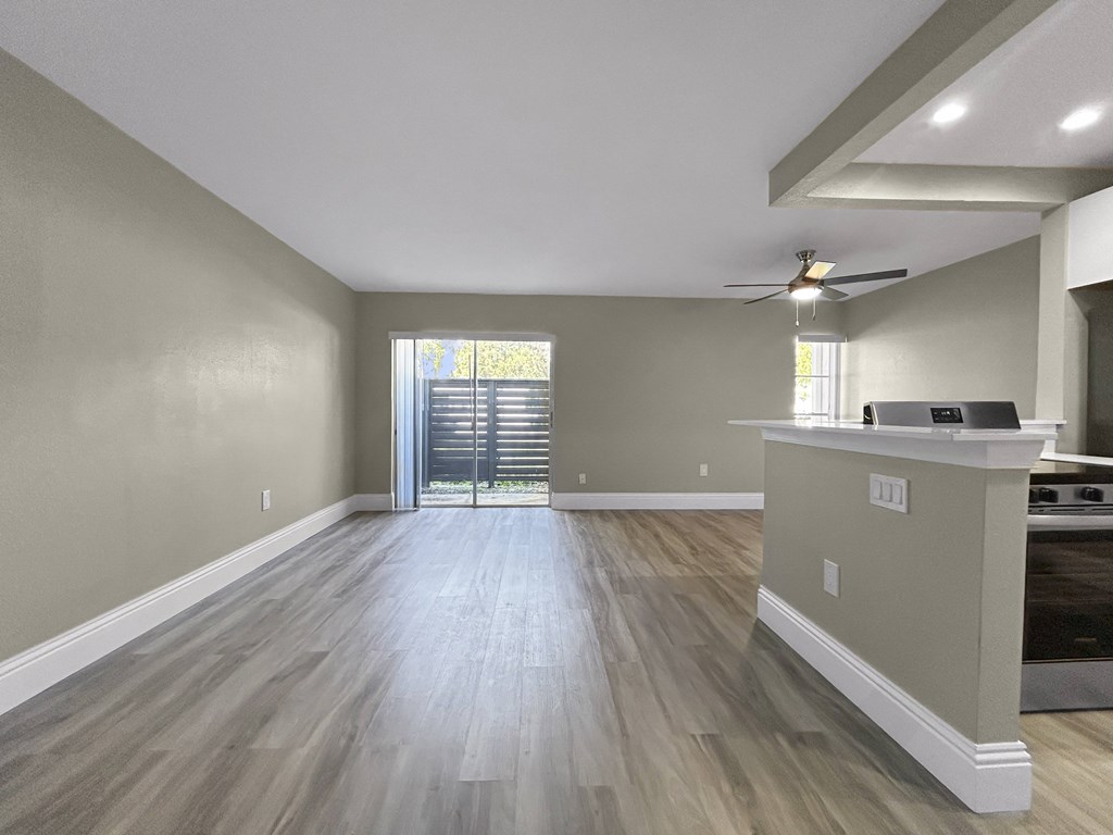 A room with a bar and a ceiling fan.