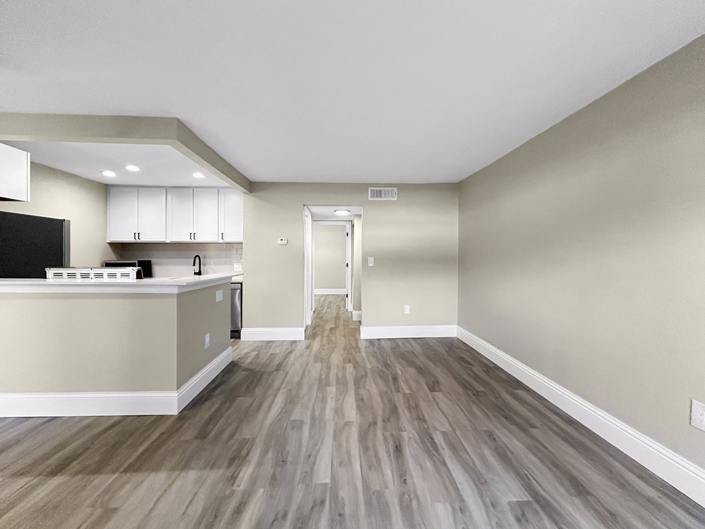 A kitchen with a countertop and cabinets is visible.