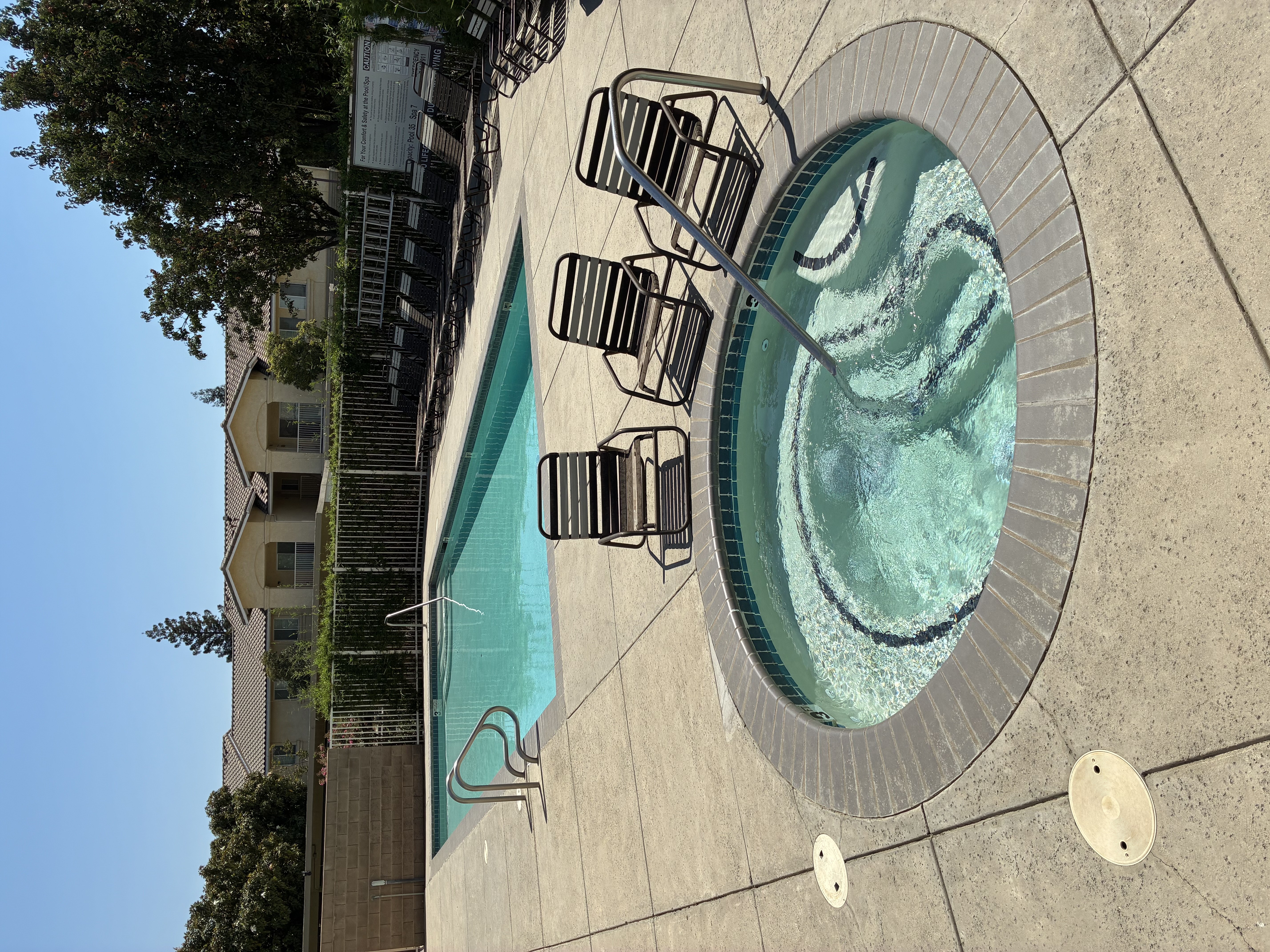 A small pool with a fountain in the middle.