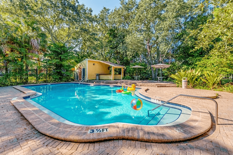 A small pool with a yellow ball in it.