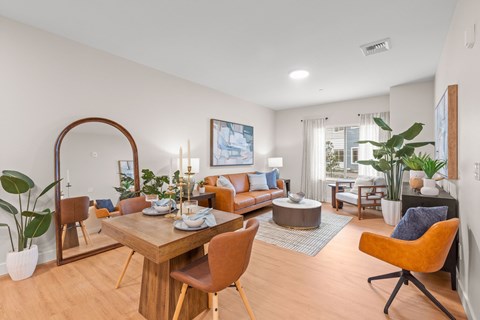 Open dining room with living area and wood flooring at The Residences at Stone Creek Apartments, Milton