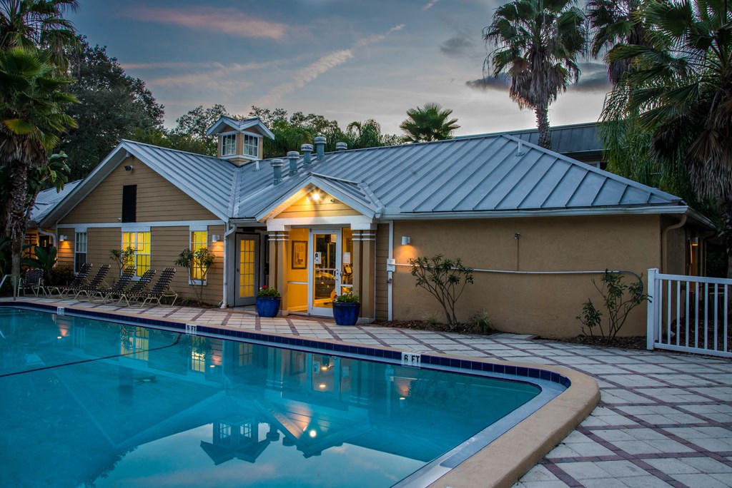 a house with a pool in front of it