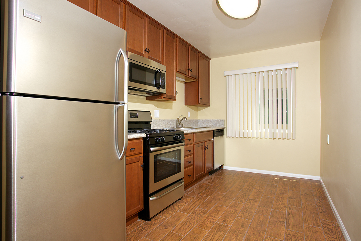 a kitchen with stainless steel appliances and wooden cabinets