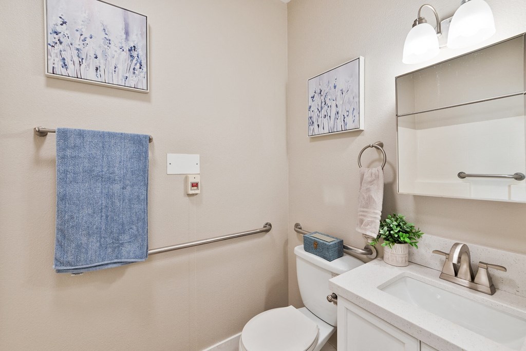 a bathroom with a toilet sink and mirror  at Azure Point at Encinitas, California