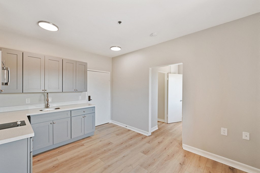 a kitchen with gray cabinets and a wooden floor at Azure Point at Encinitas, California