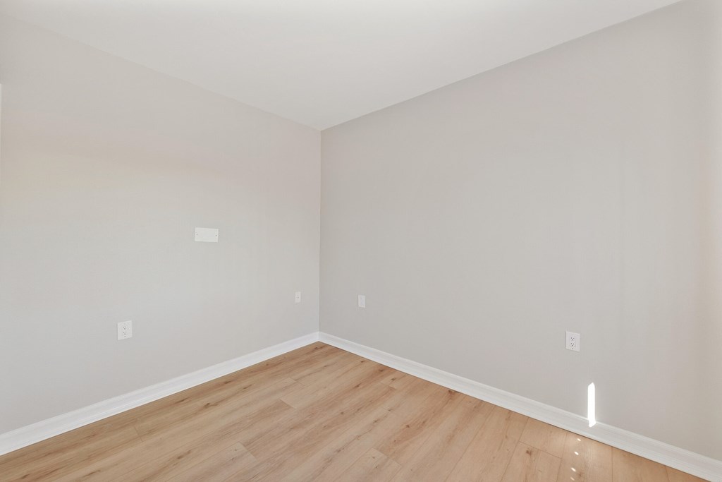 a bedroom with grey walls and a wooden floor at Azure Point at Encinitas, Encinitas California