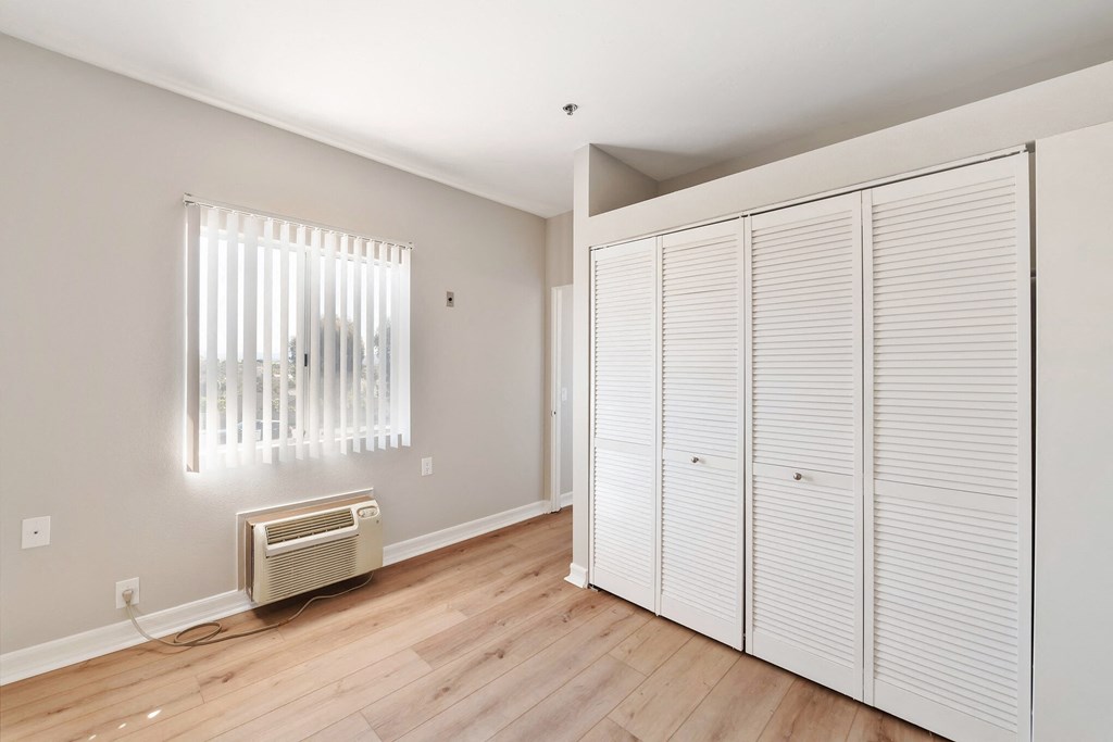 a bedroom with two closets and a radiator at Azure Point at Encinitas, Encinitas, 92024