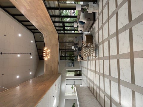 A modern kitchen with a wooden counter and white cabinets.