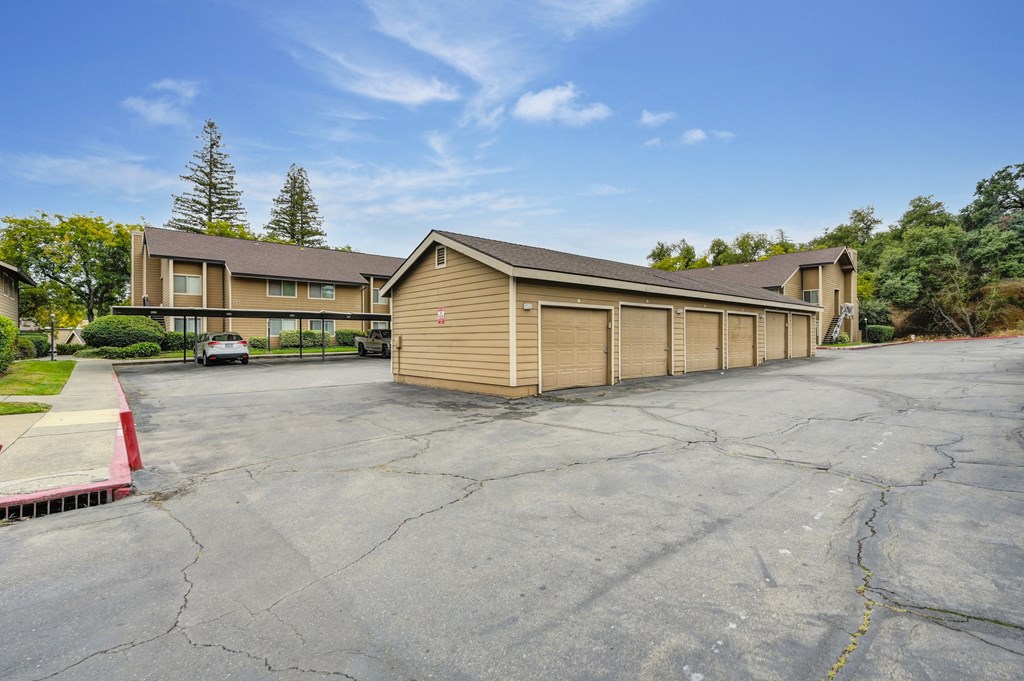a large parking lot in front of a building with garages