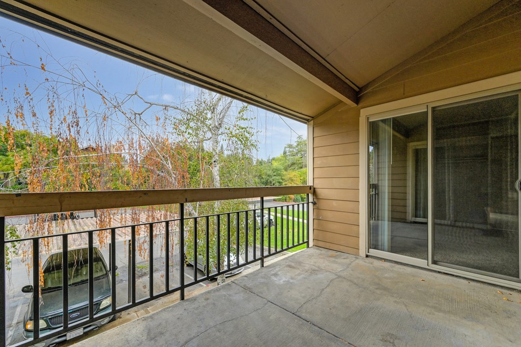 the deck has a view of the woods and a patio