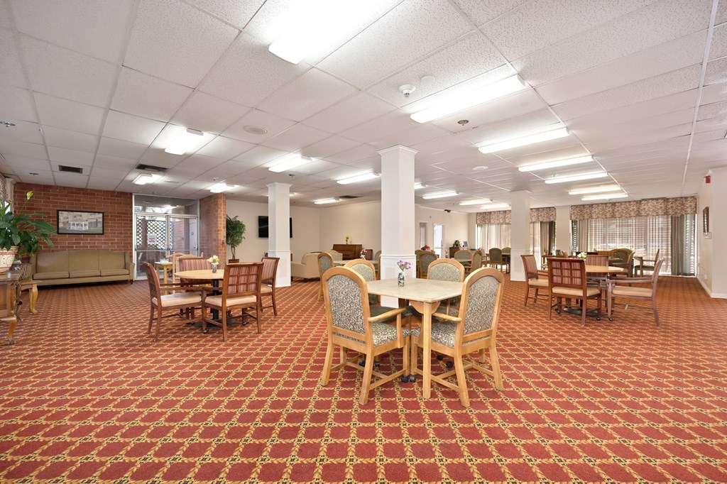 A large room with tables and chairs.