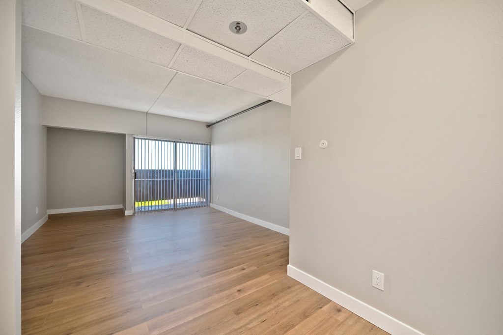 A room with wooden floors and white walls.