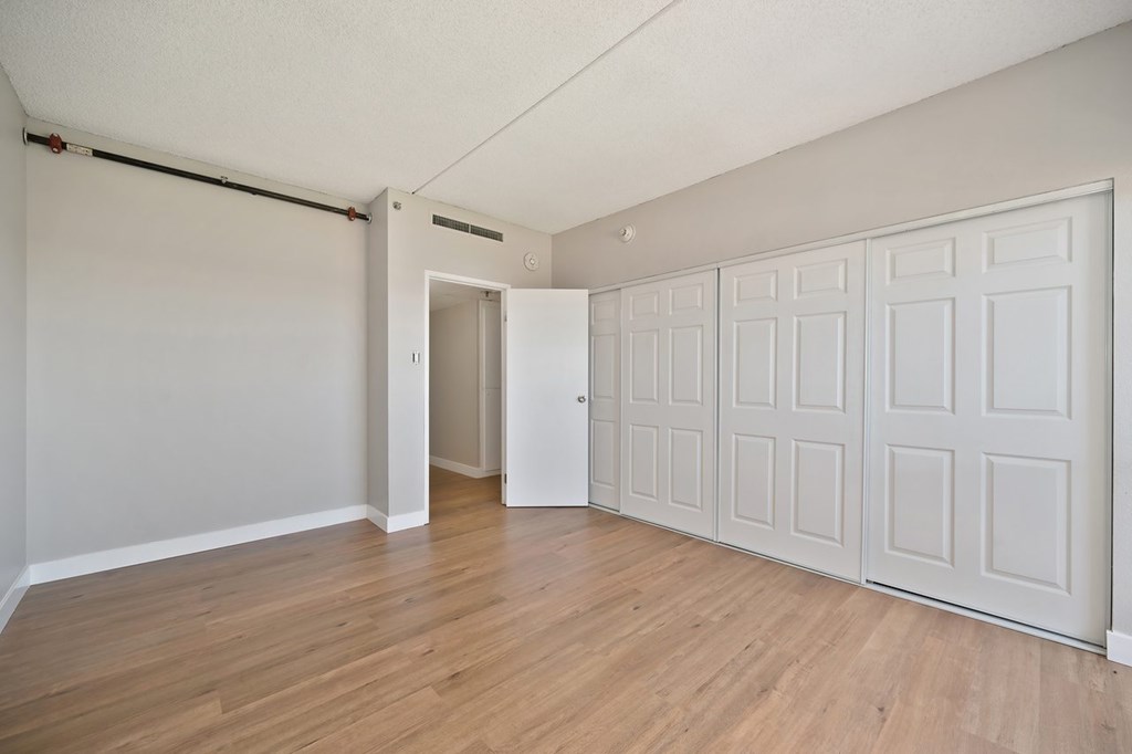 A room with a white door and a white wardrobe.