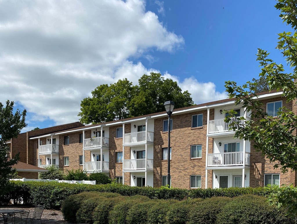 an apartment building with brick exterior and balconies