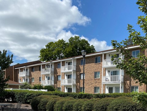 an apartment building with brick exterior and balconies