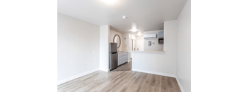 A kitchen with a refrigerator, microwave, and oven.