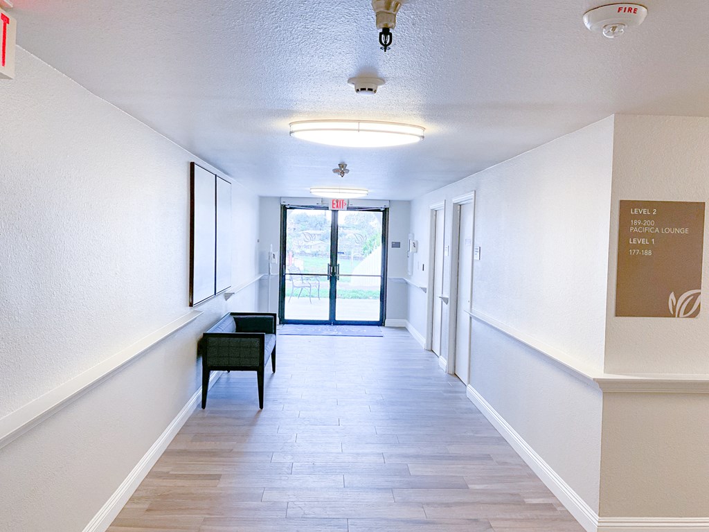 a hallway with white walls and a sliding glass door