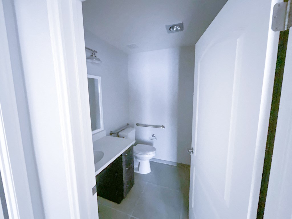 a bathroom with a toilet sink and mirror
