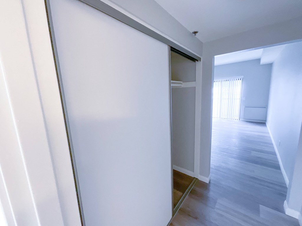 a sliding glass door separates the bedroom from the living room