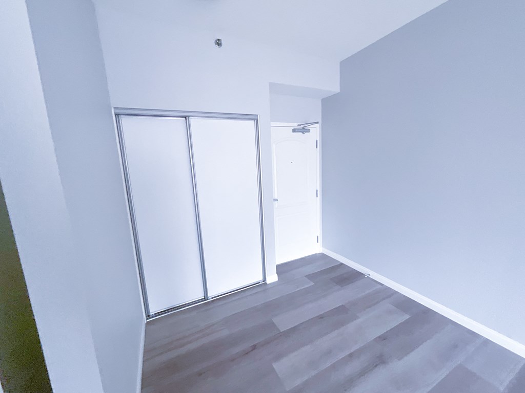 an empty room with white walls and a white door