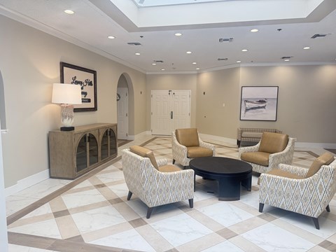 A living room with a checkered floor and a sofa set.