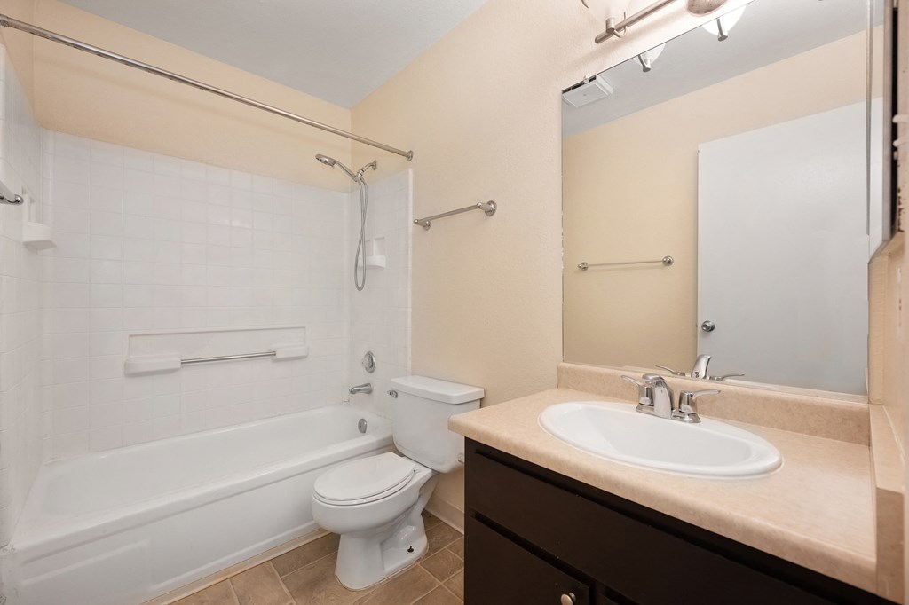 a bathroom with a sink and a toilet and a bath tub