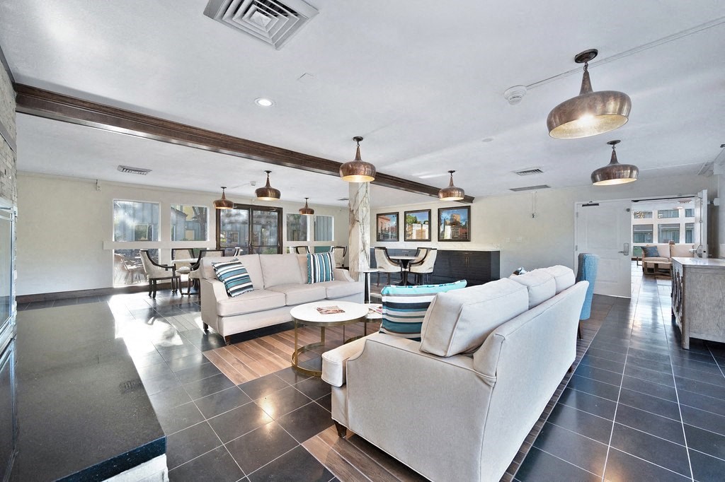 a living room filled with furniture and a large window at The Crest at Citrus Heights Apartments, California