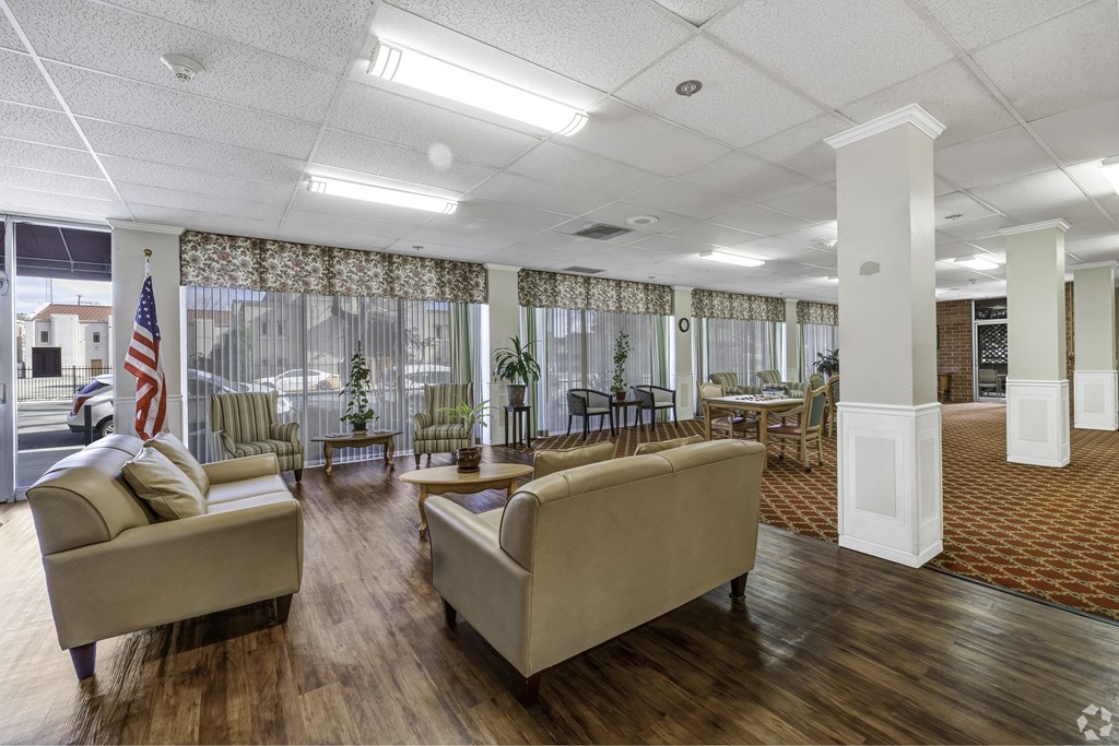 a lobby with couches and chairs and a flag