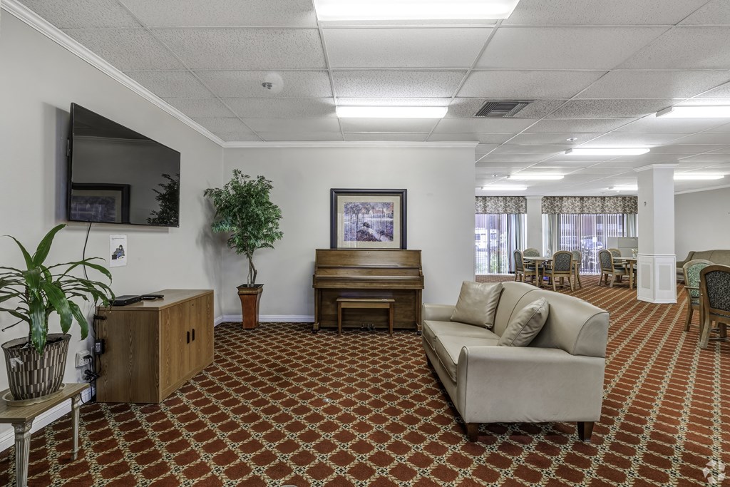 a living room with a couch and a piano