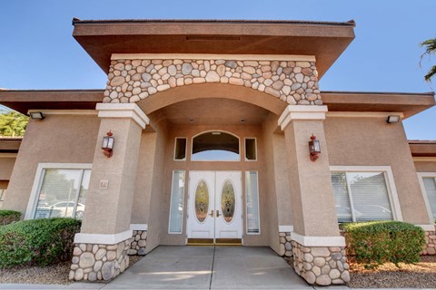A house with a stone archway entrance and two doors.