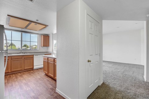 A kitchen with wooden cabinets and a white door.