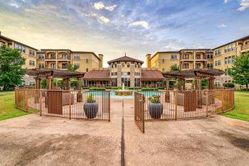 A large building with a pool in front of it.