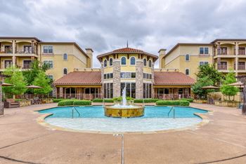 A large building with a fountain in front of it.