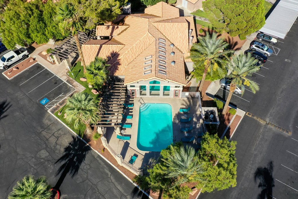 A large building with a pool in the middle of a parking lot.