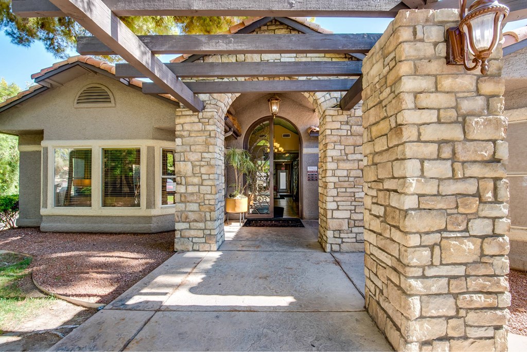 A house with a stone pillar and archway entrance.
