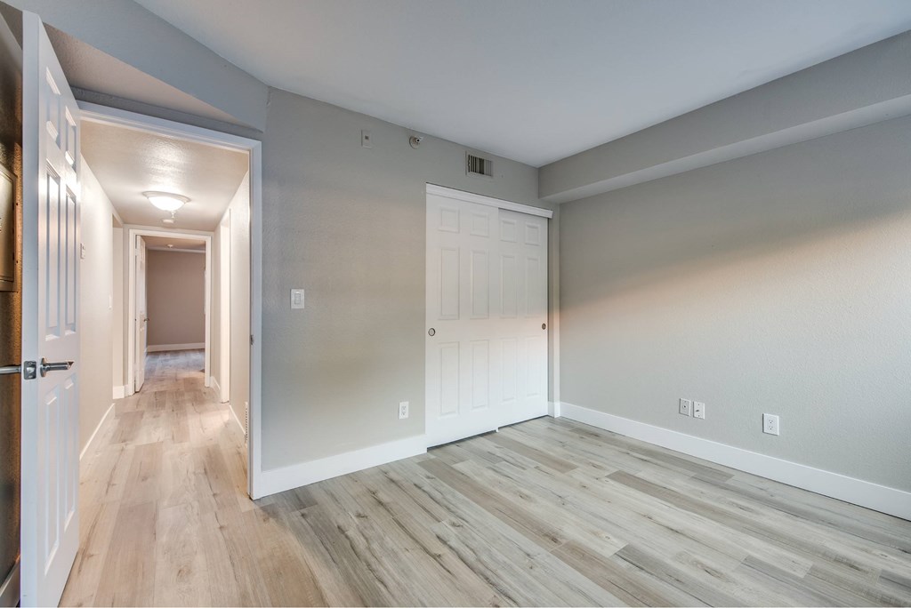 A room with wooden floors and white walls.
