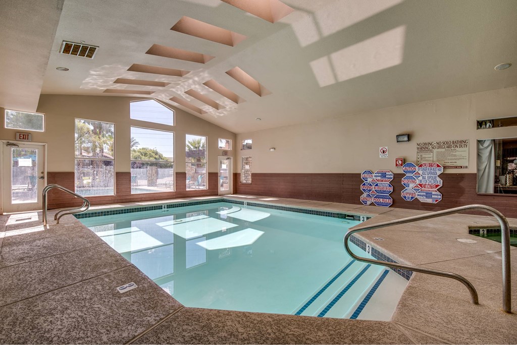 A large indoor swimming pool with a skylight above it.