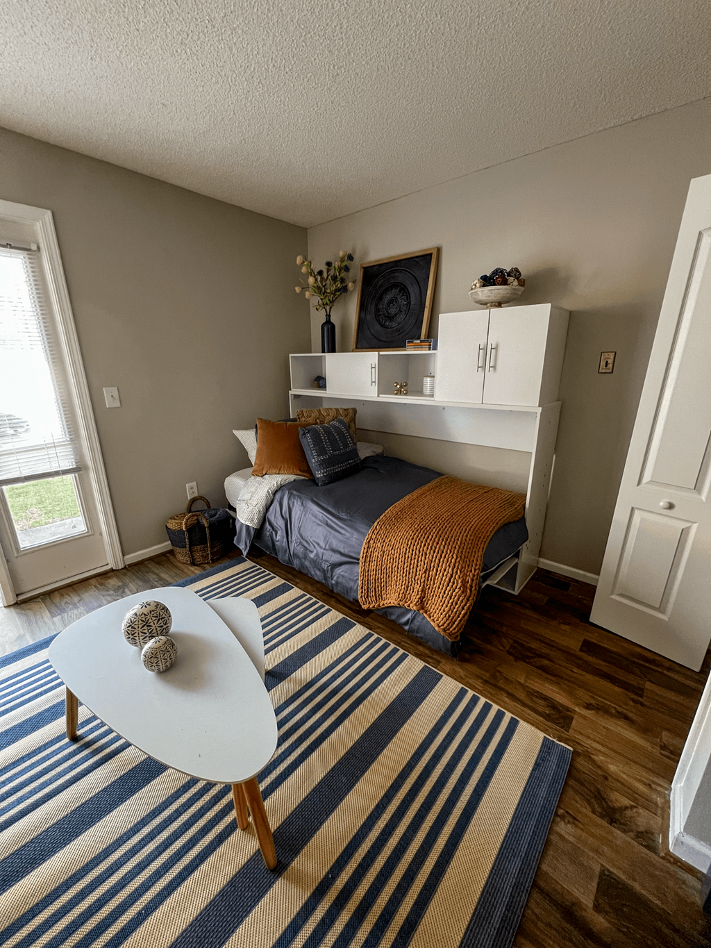 a bedroom with a bed and a table in the corner