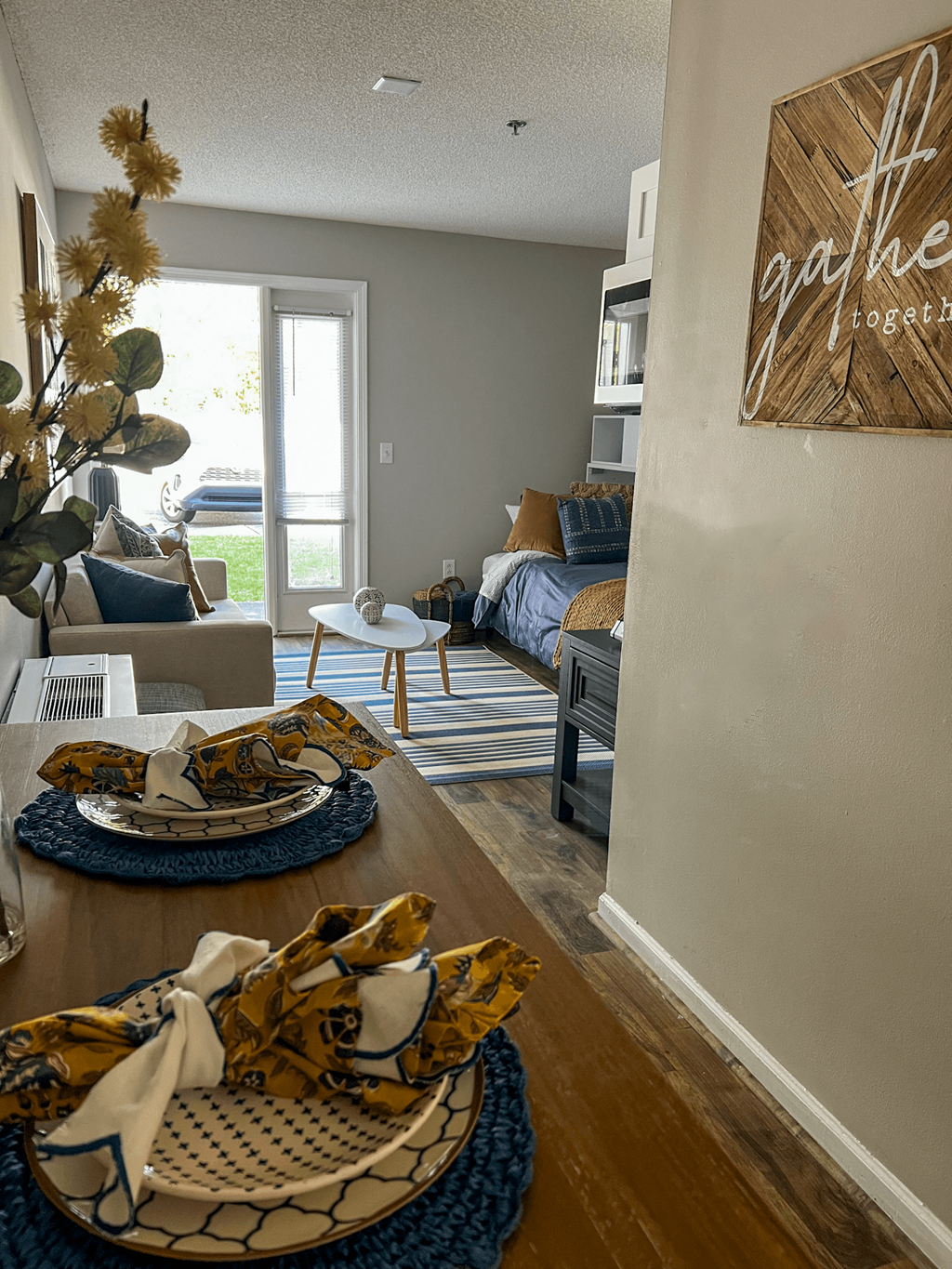 a living room and dining room with a table with plates on it