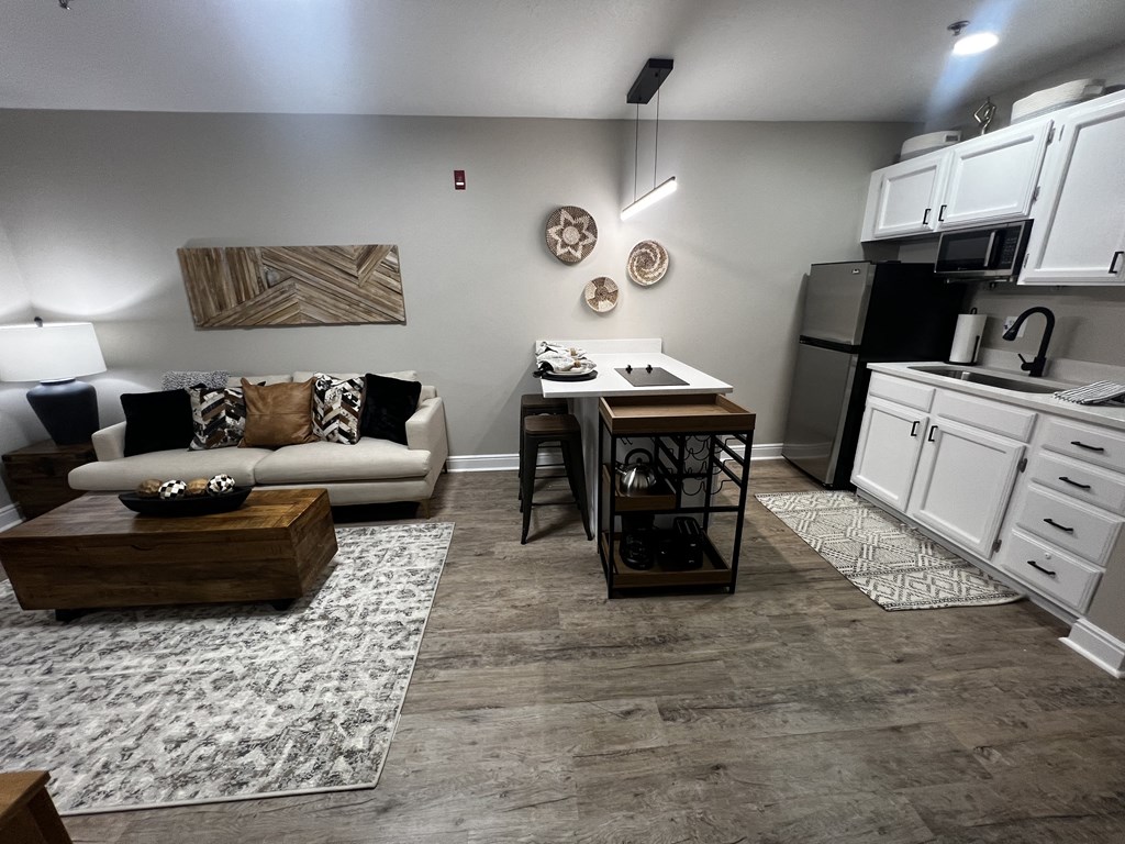 a kitchen and living room with a couch and a table