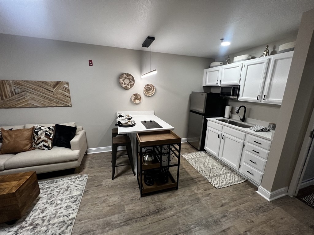a kitchen and living room with a couch and a table