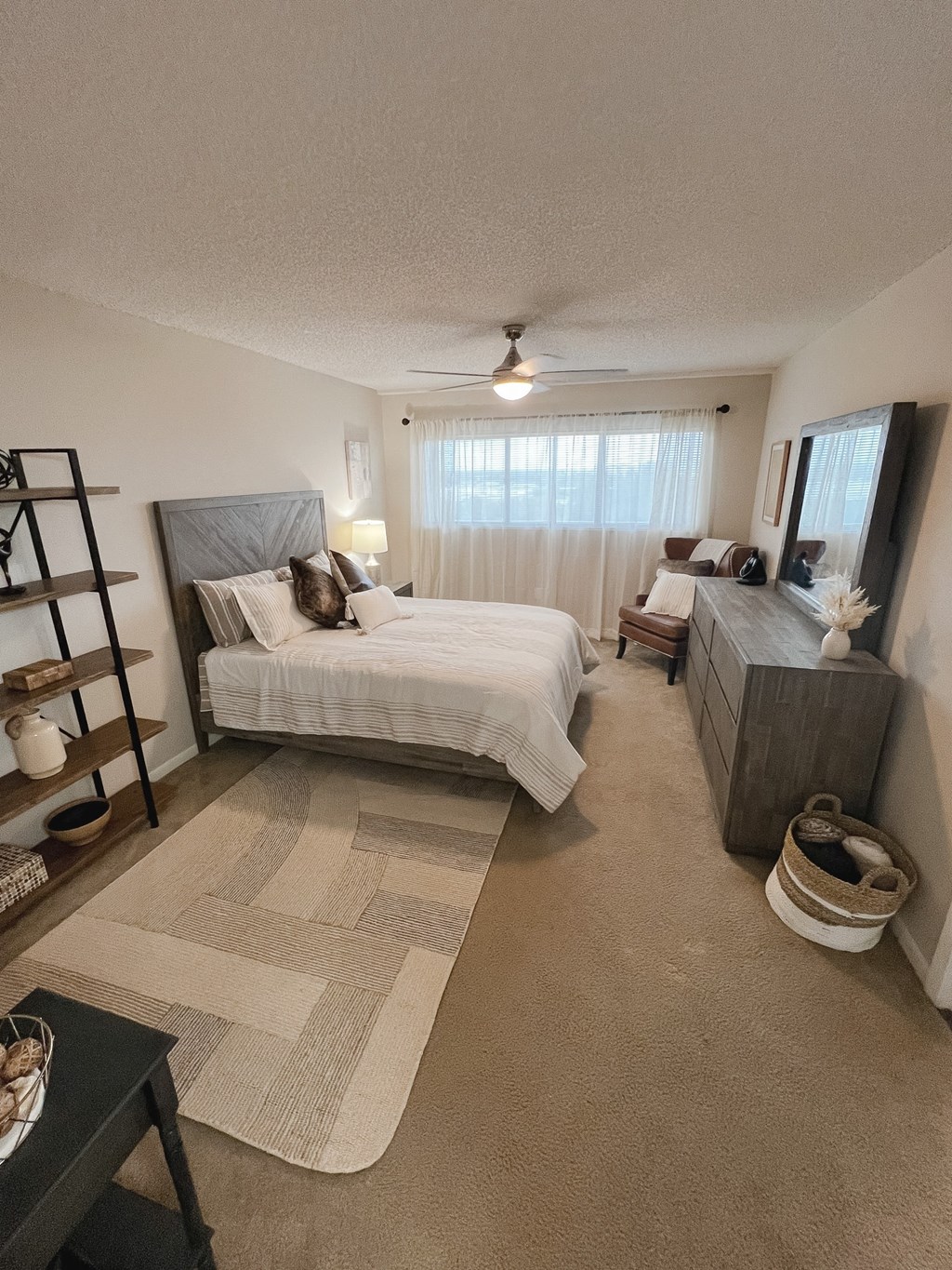 a bedroom with a bed and a dresser and a window