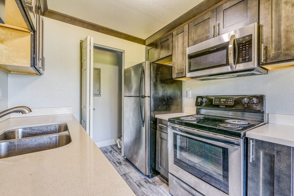 a kitchen with stainless steel appliances and a sink