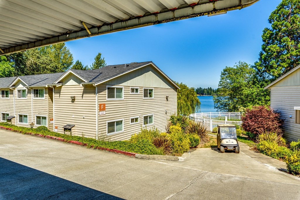 a white house with a golf cart parked in front of it